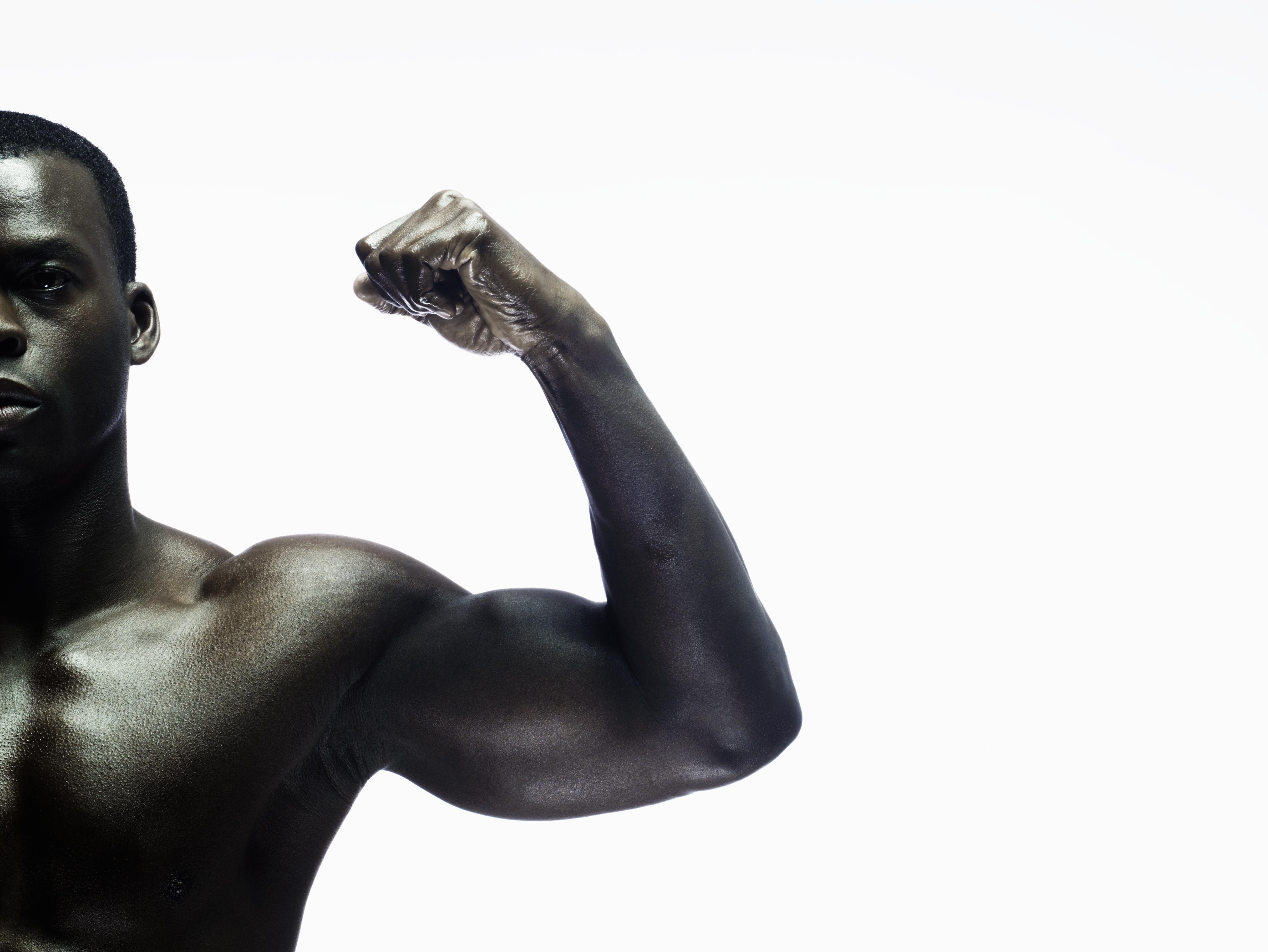 Man showing biceps, portrait, close-up