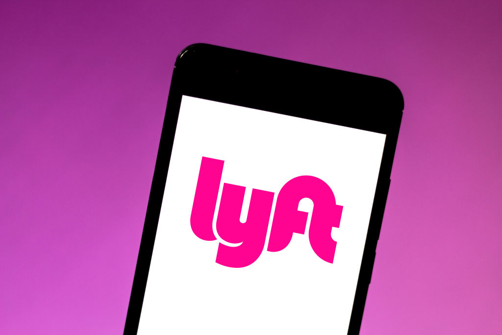 In this photo illustration the Lyft logo is seen displayed...