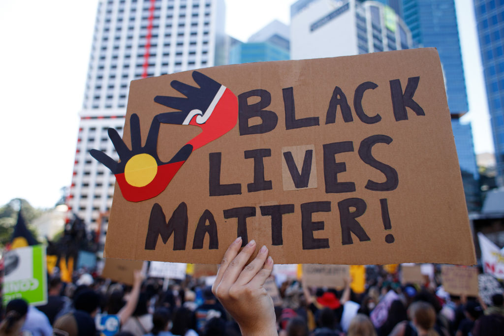 Protesters display a huge placard reading "Black Lives...