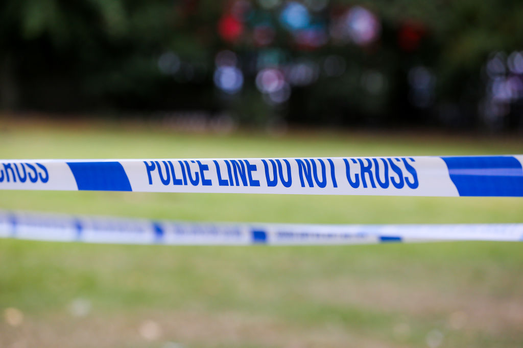 Police tape with 'Police Line Do Not Cross' written on it...