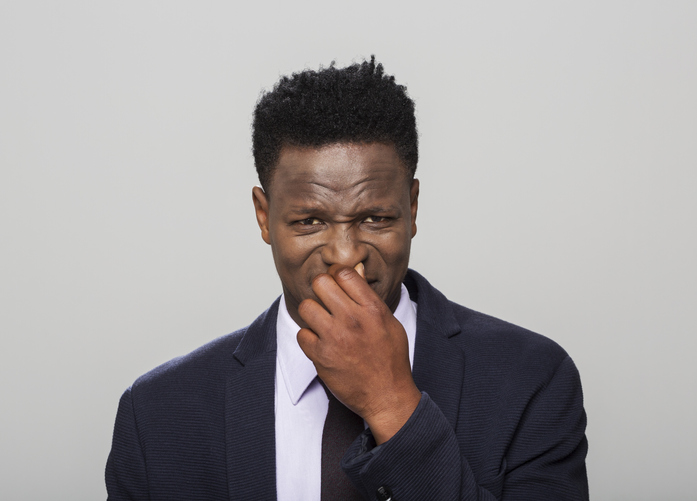 Portrait of man holding nose
