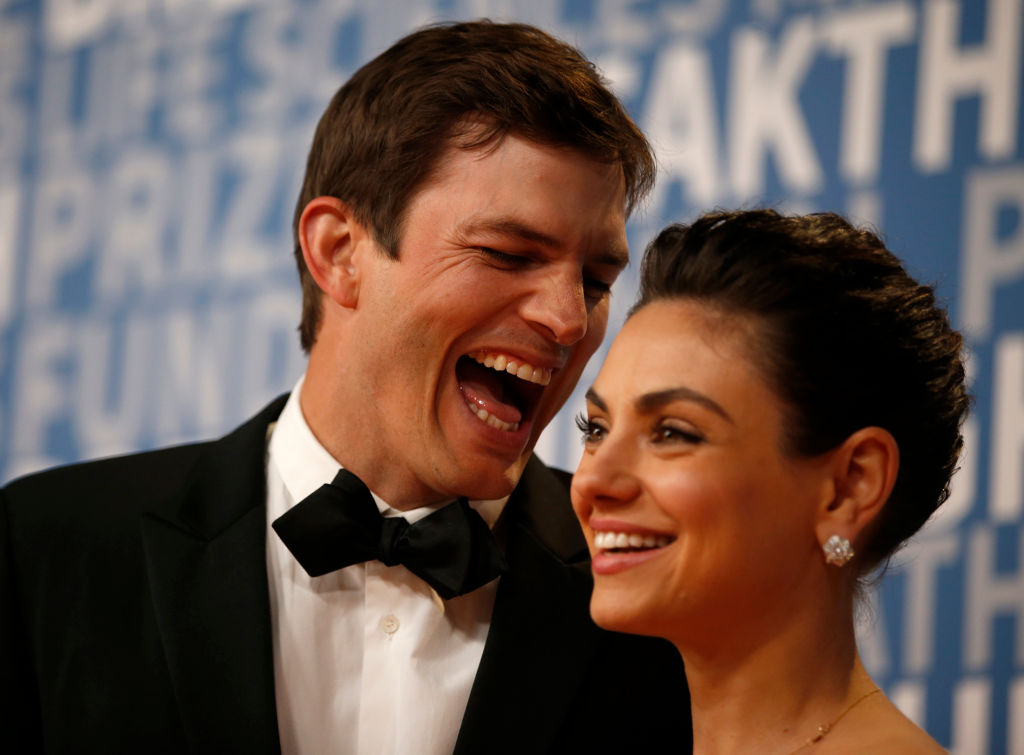 Actor Ashton Kutcher laughs with his wife actress Mila Kunis while posing for pictures on the red carpet for the 6th annual 2018 Breakthrough Prizes at Moffett Federal Airfield, Hangar One in Mountain View, Calif., on Sunday, Dec. 3, 2017. (Nhat V. Meyer/