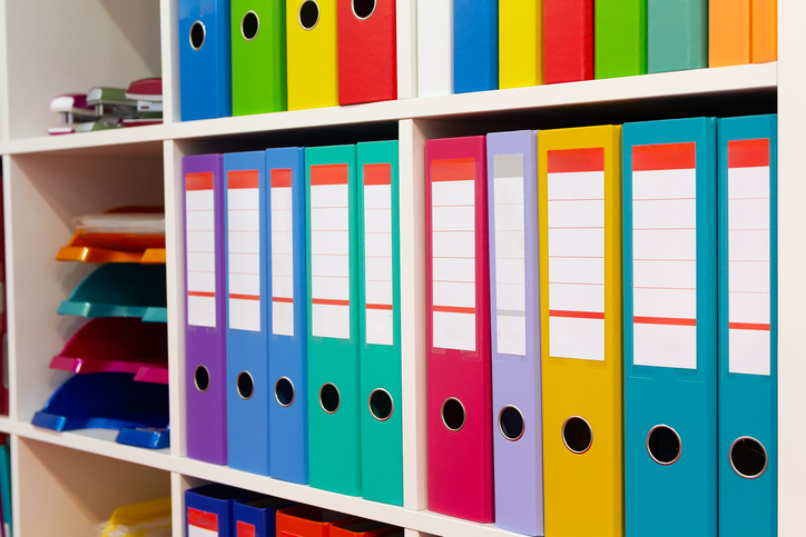 Colorful folders on a shelf in a modern office space
