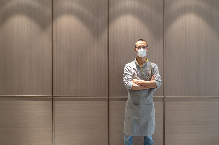 Man in apron wearing mask