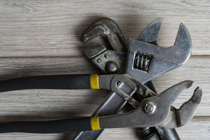 Assorted Wrenches on Wooden Workbench