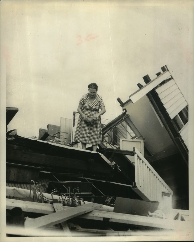 1961 Press Photo Woman stands atop her ruined home - Hurricane Carla - Texas